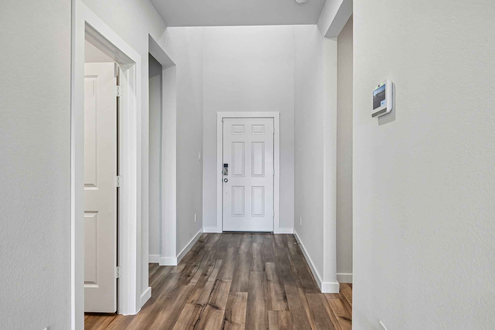 A hallway with white doors.