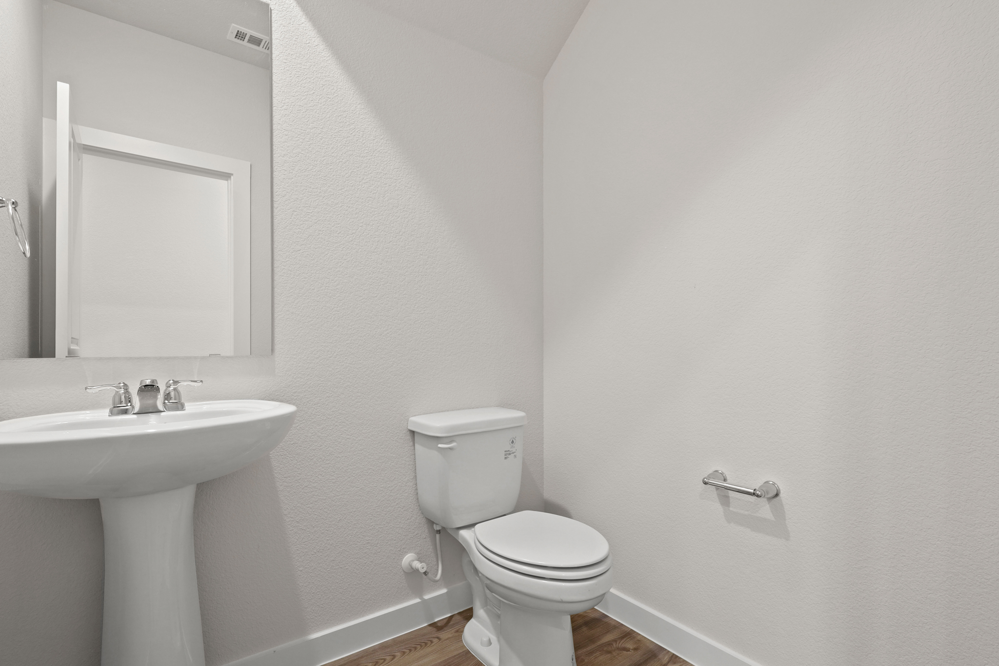 A bathroom with a toilet and sink.