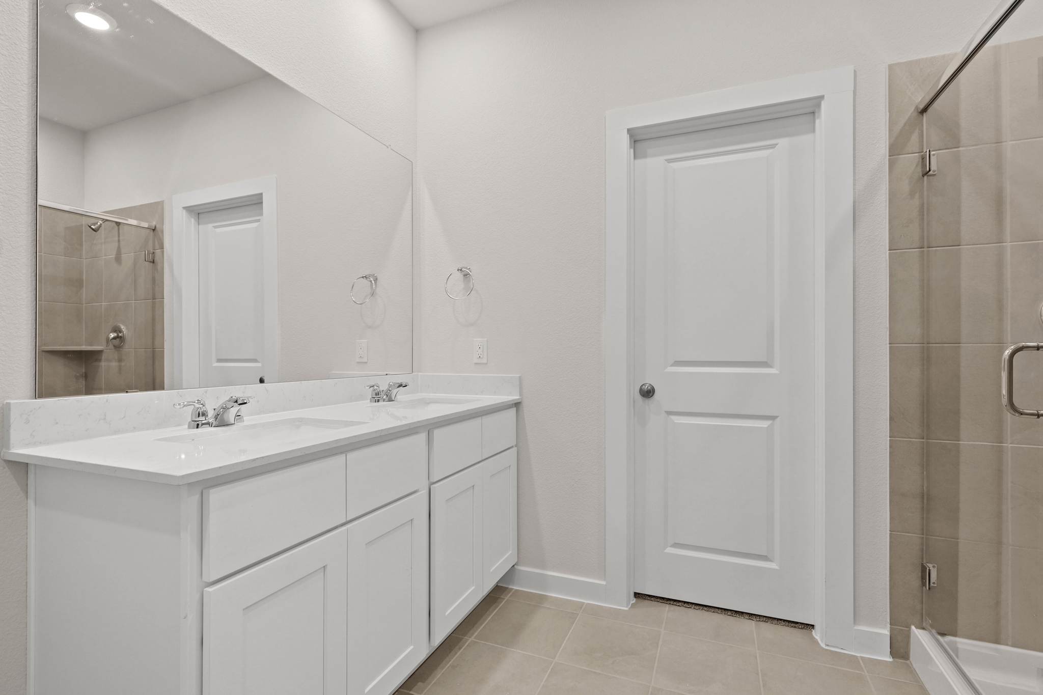 A bathroom with a shower and sink.