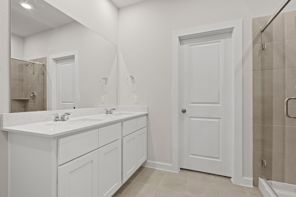 A bathroom with a shower and sink.