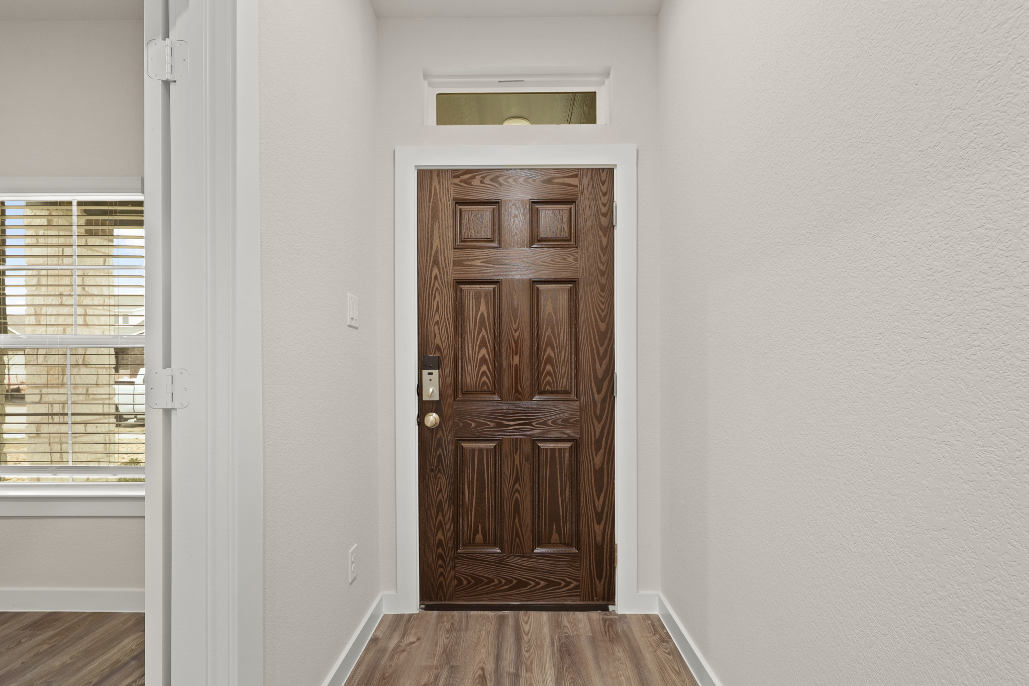 A wooden door in a room.
