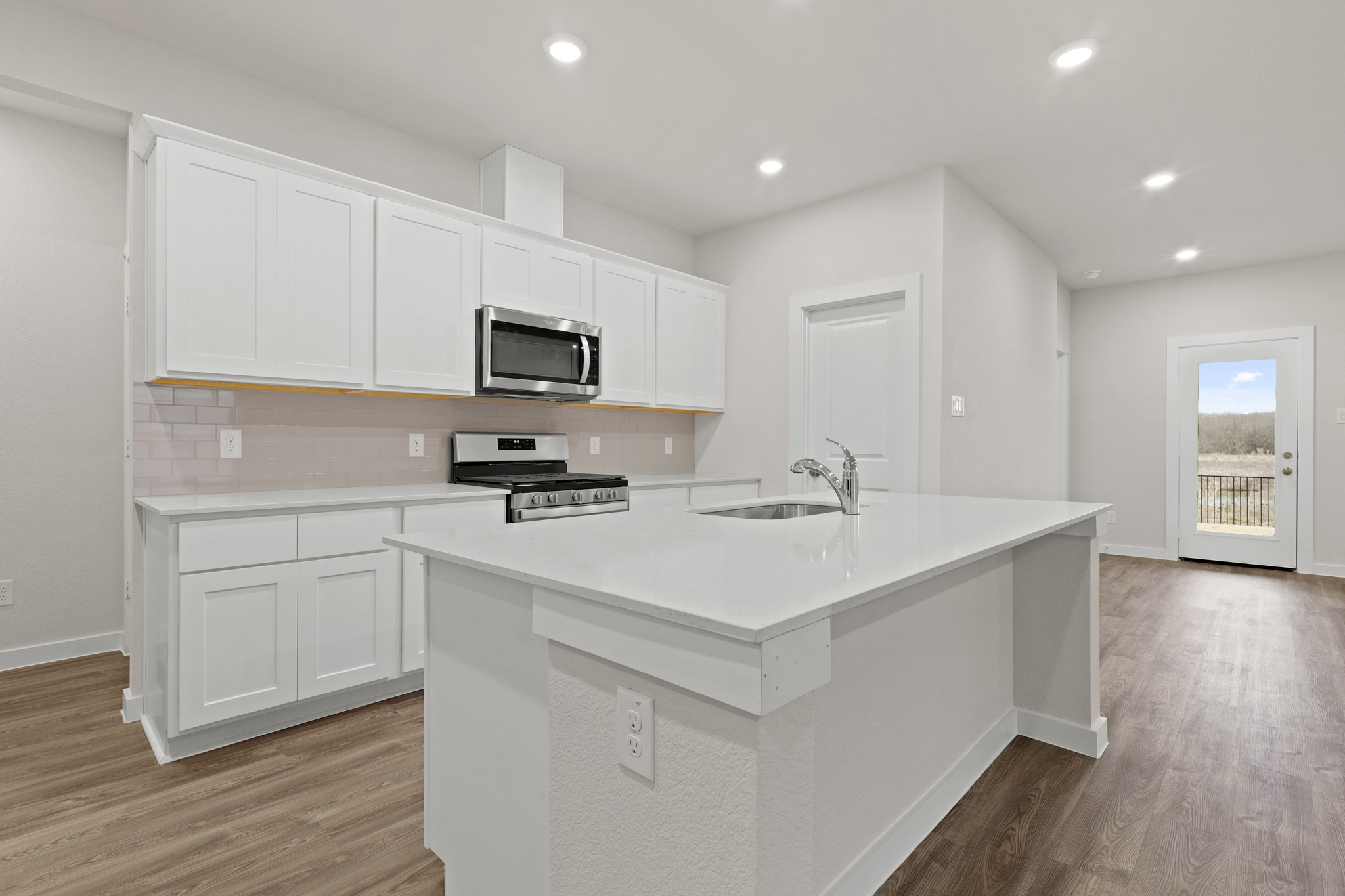 A kitchen with white cabinets.