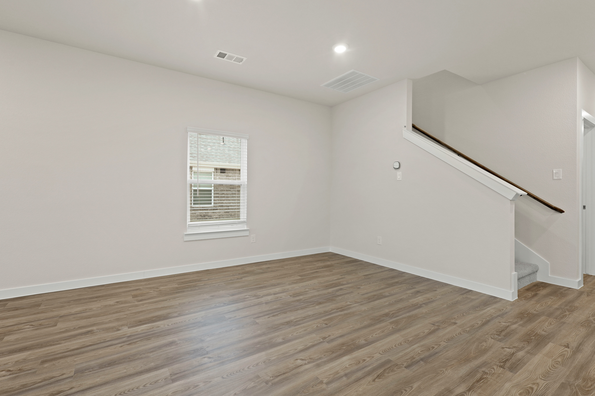 A room with a wood floor and a wood floor.