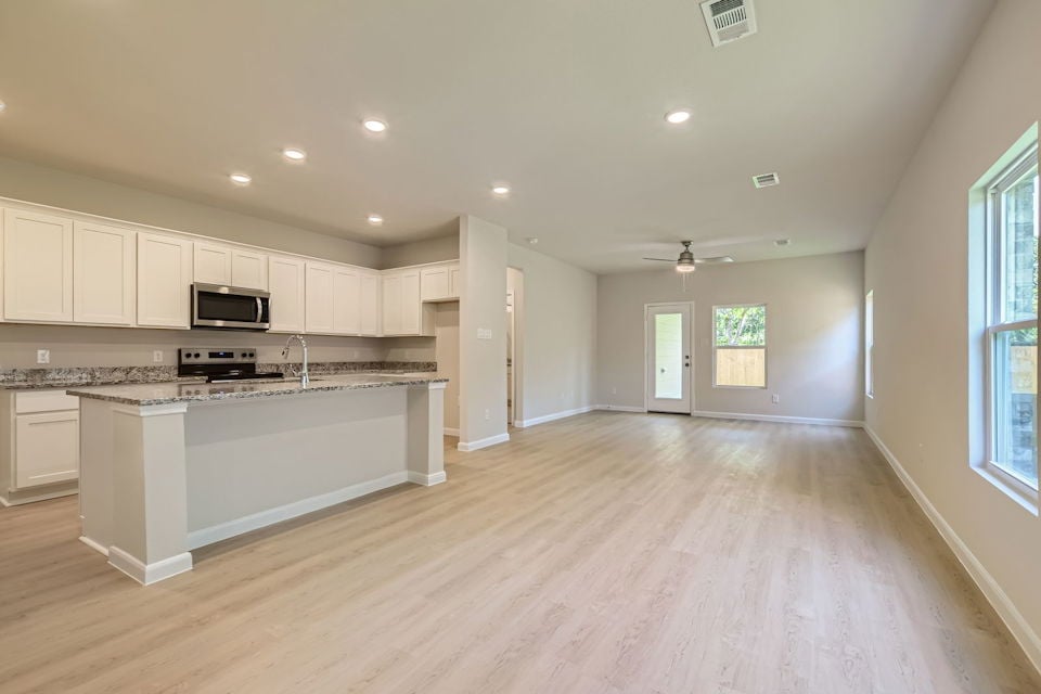 A large kitchen with white cabinets.