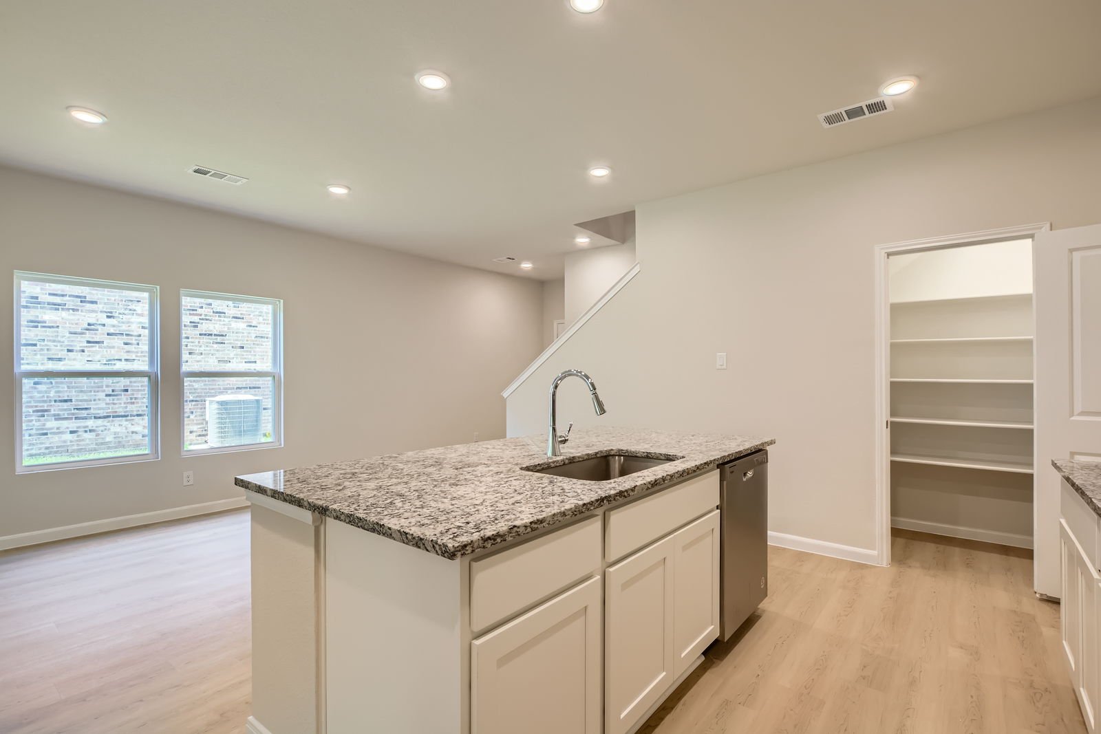A kitchen with a marble countertop.
