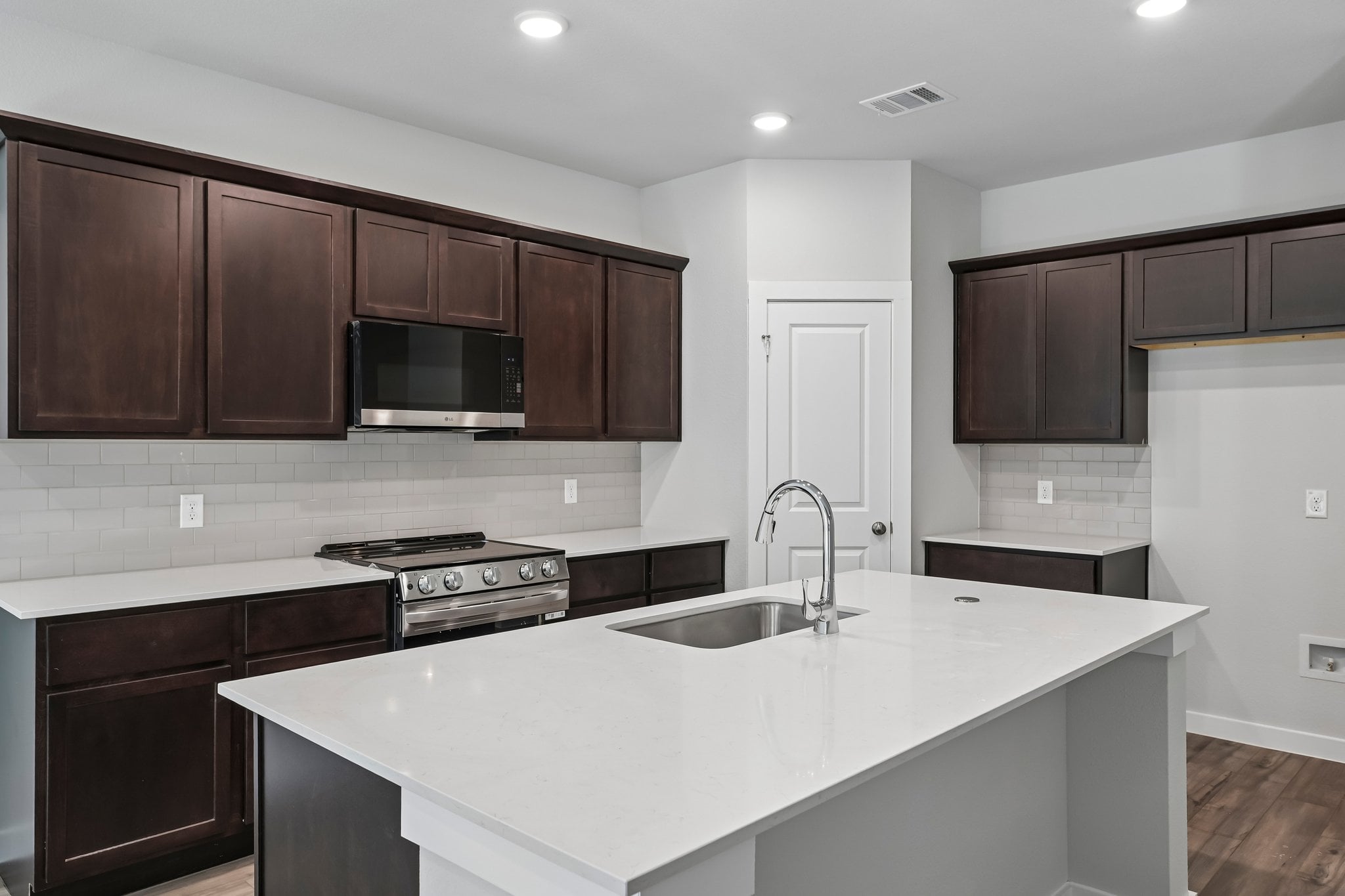 A kitchen with black cabinets.