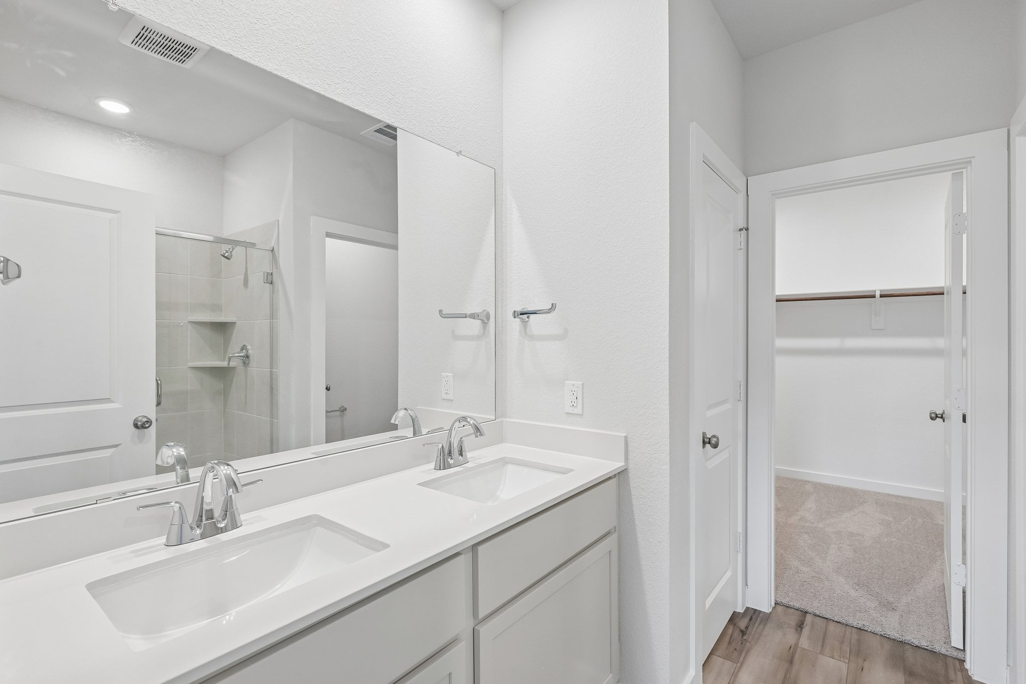 A bathroom with a large mirror.
