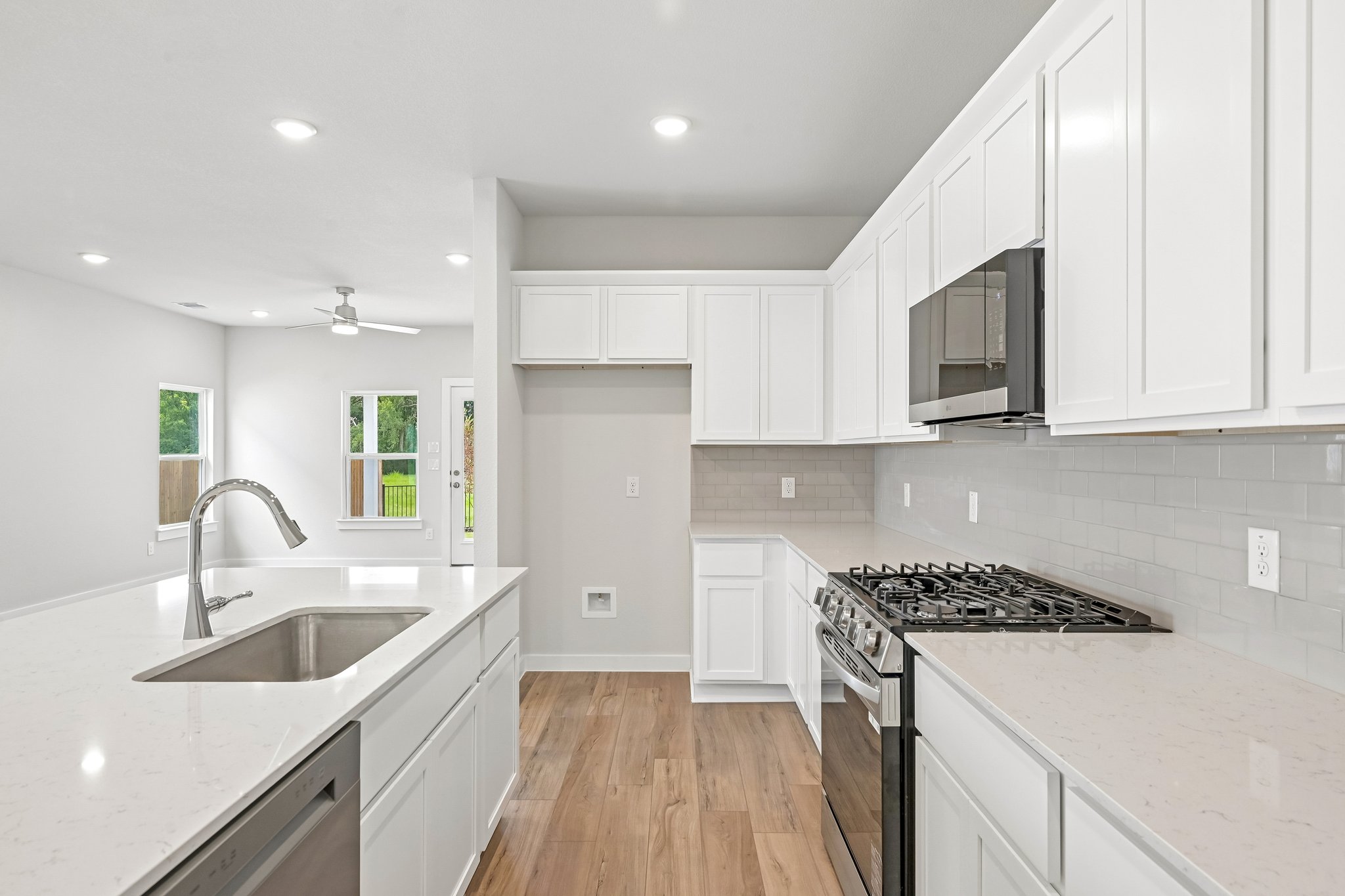 A kitchen with white cabinets.