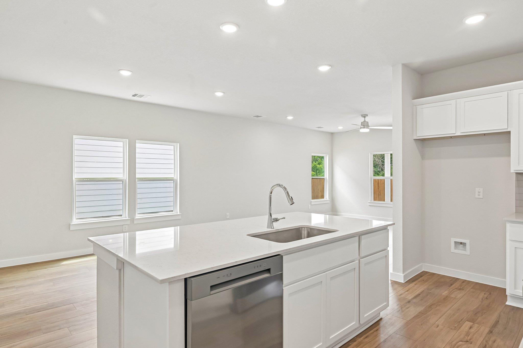 A kitchen with white cabinets.