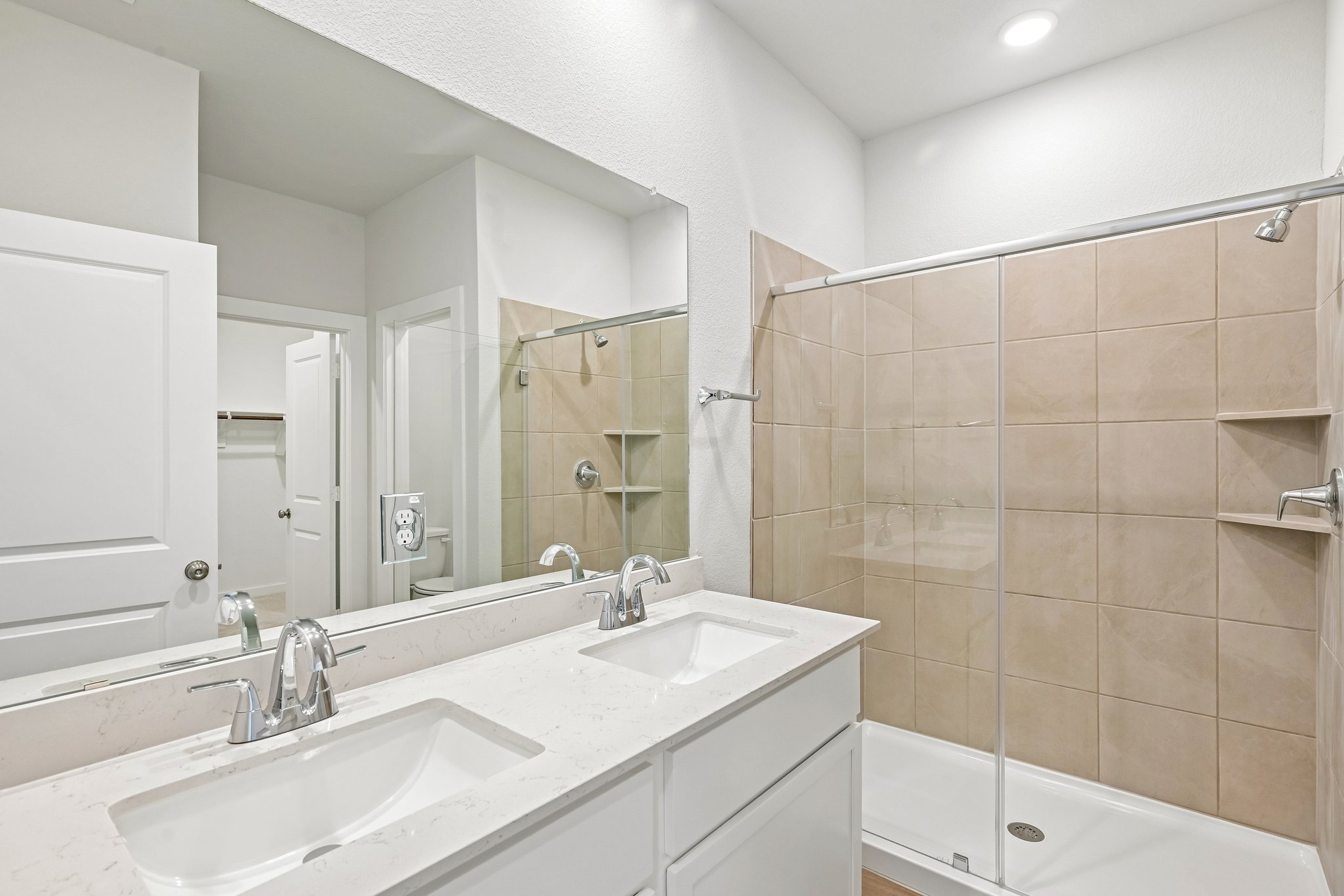 A bathroom with a large mirror.