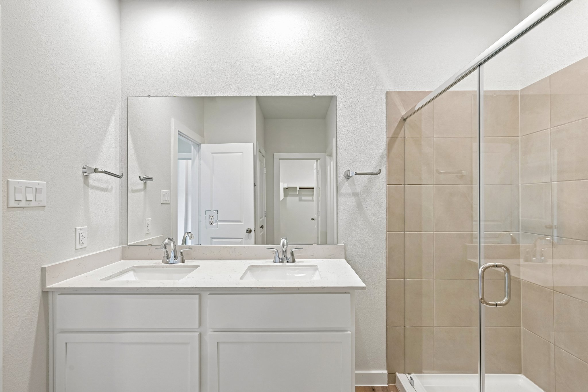 A bathroom with a glass shower.