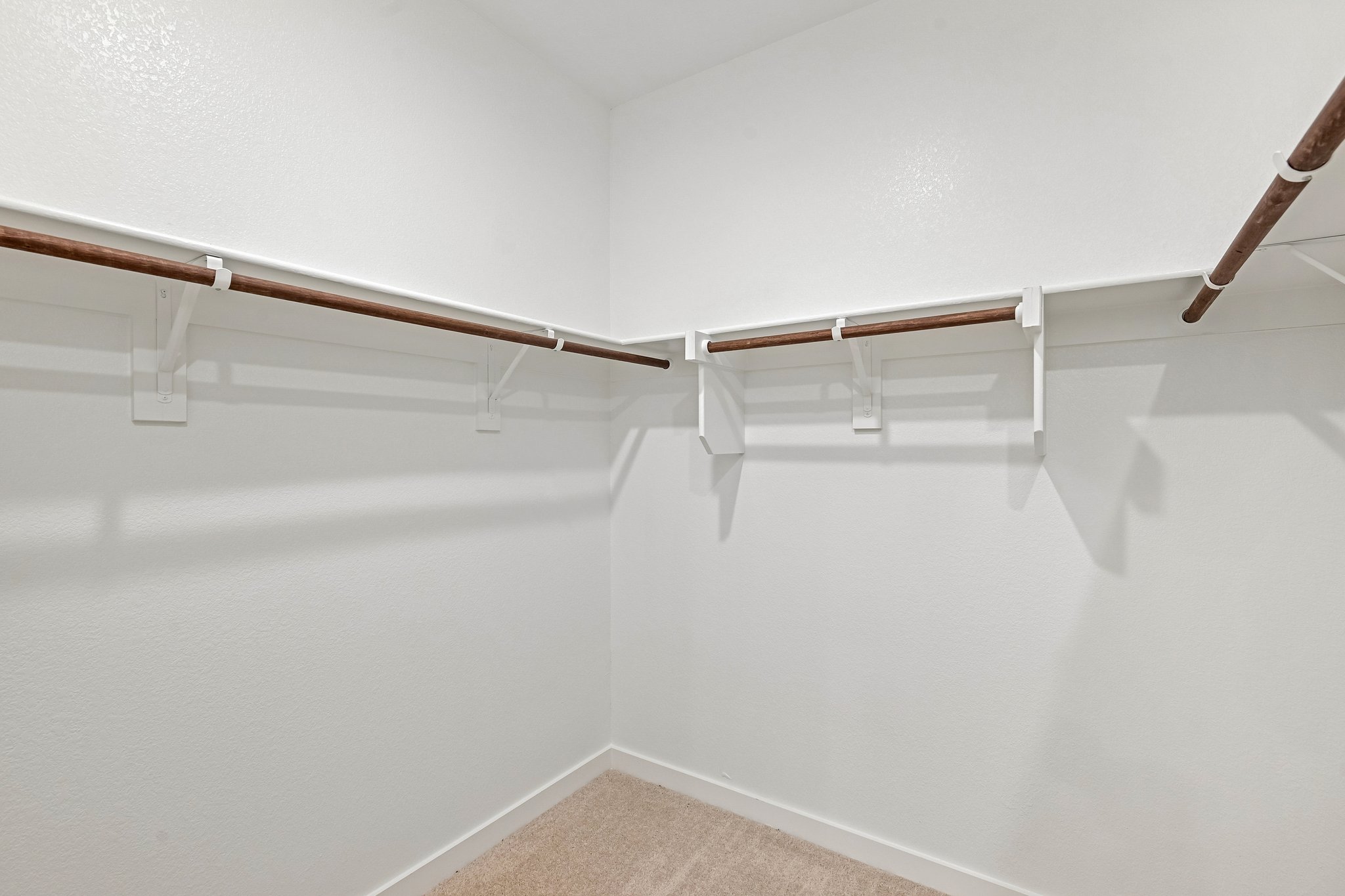 A white wall with a wooden railing.