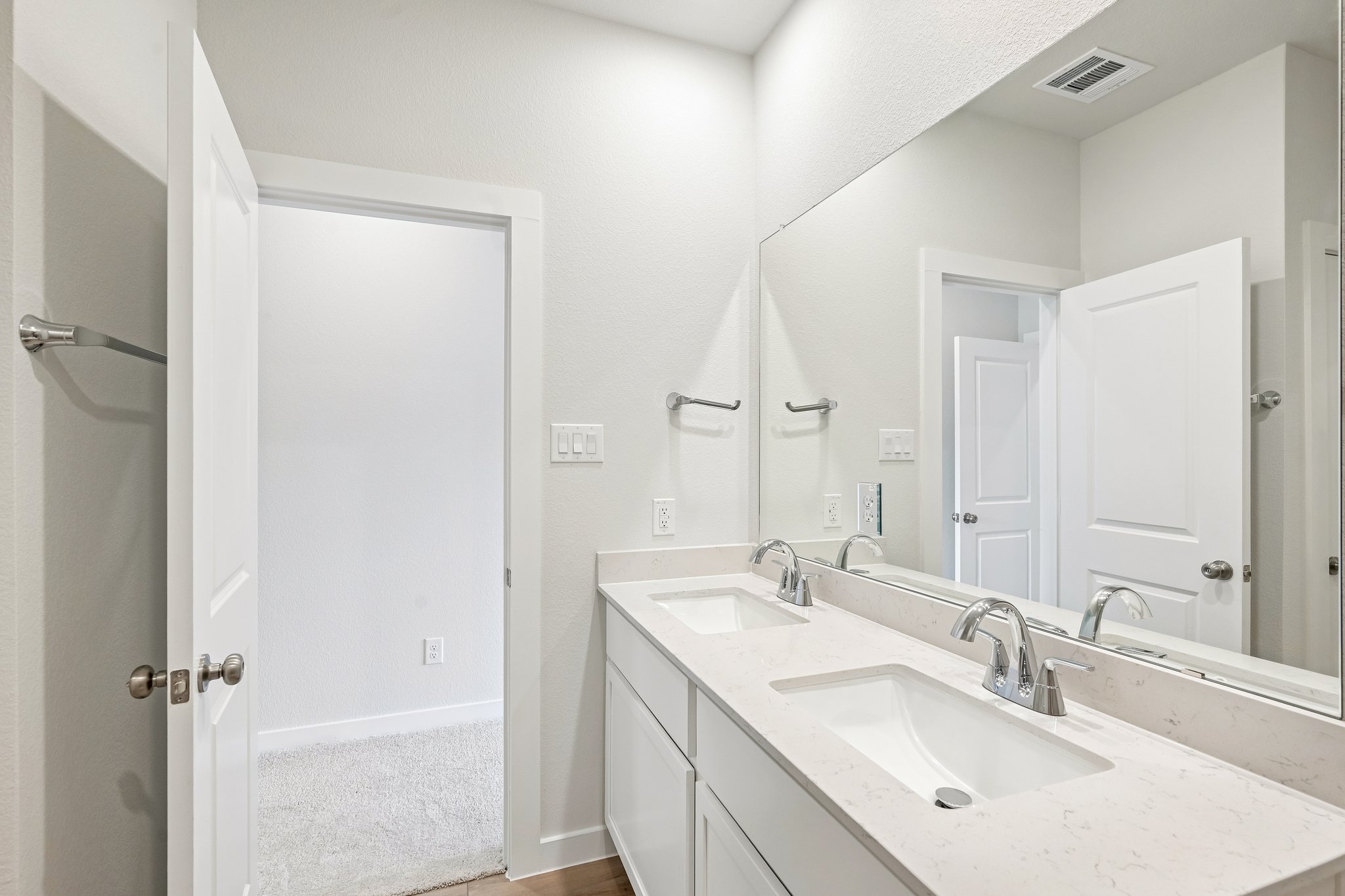 A bathroom with a large mirror.