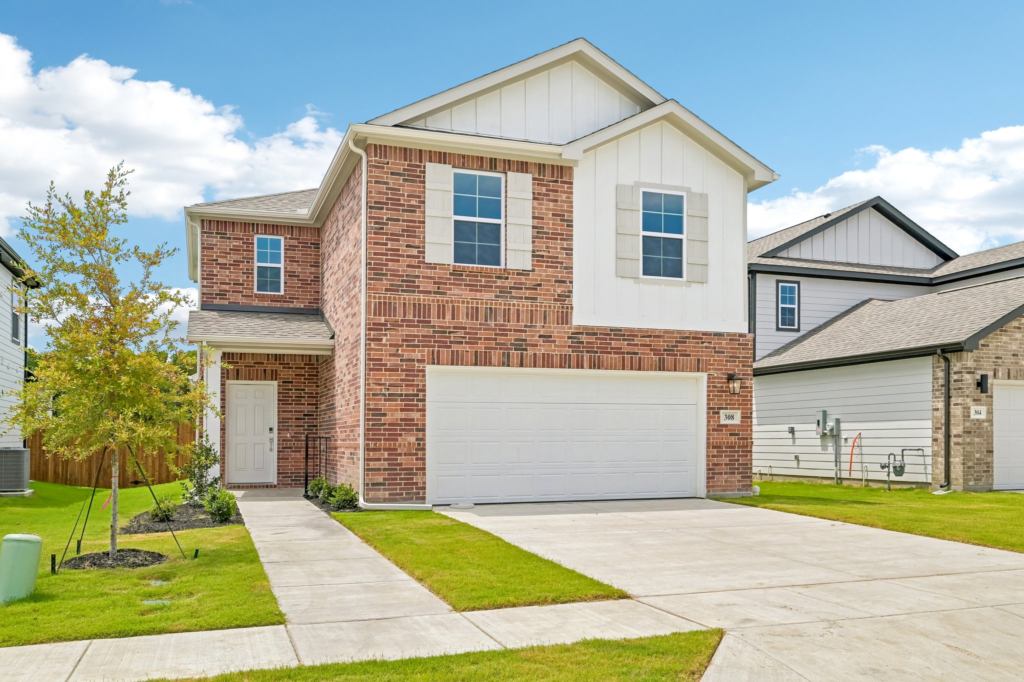 A brick house with a garage.
