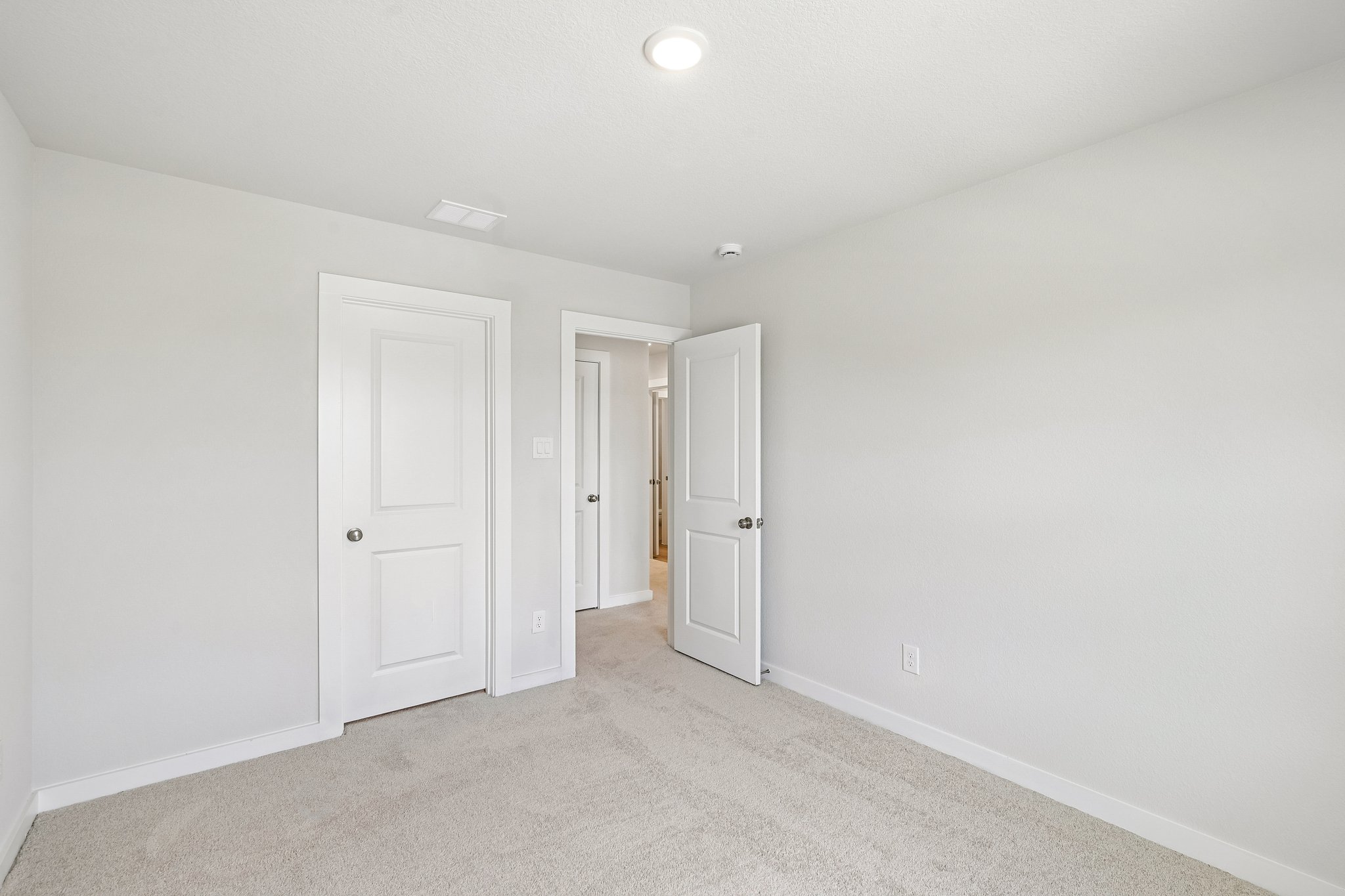 A hallway with white doors.