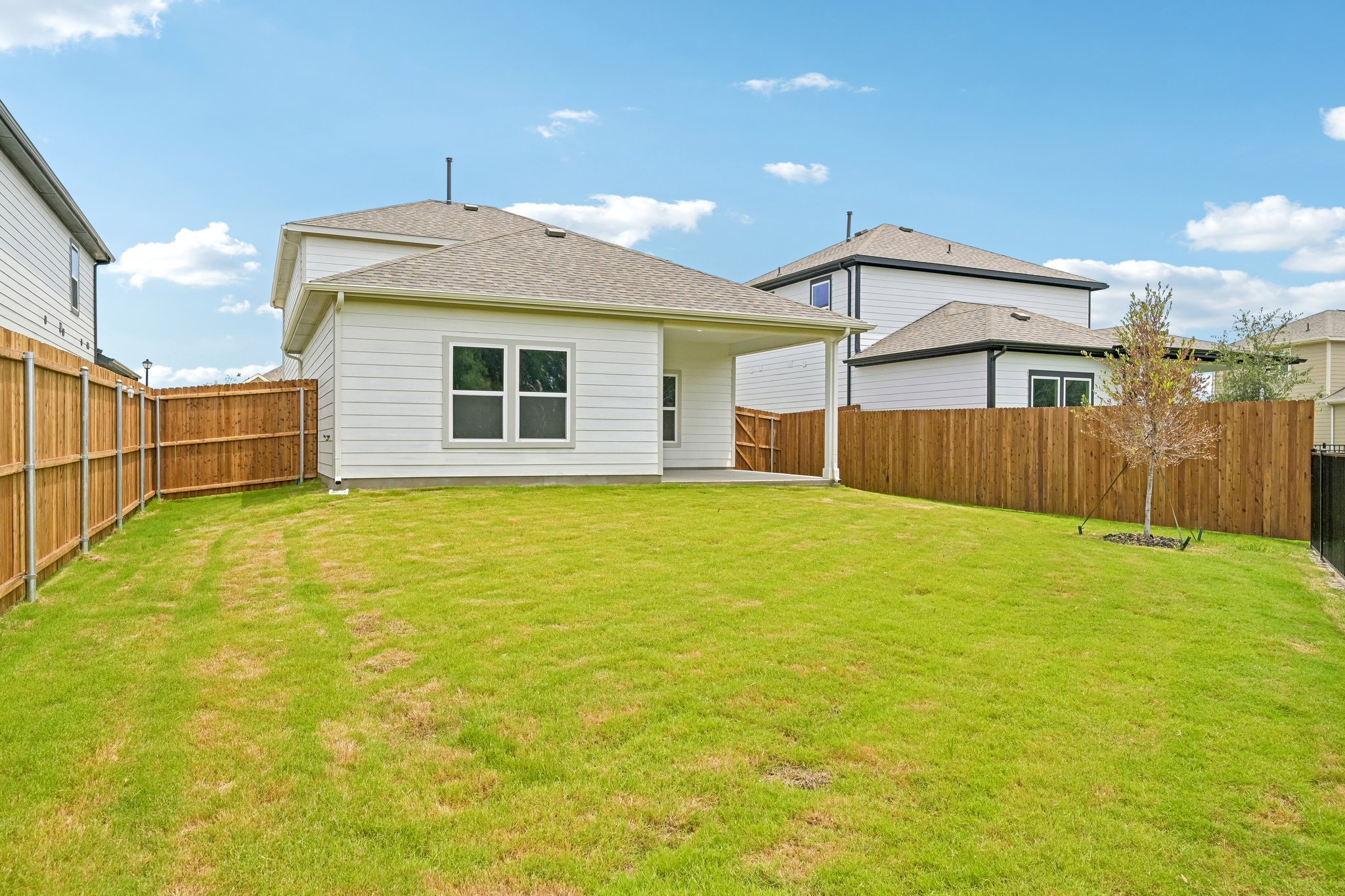 A house with a fence and grass.