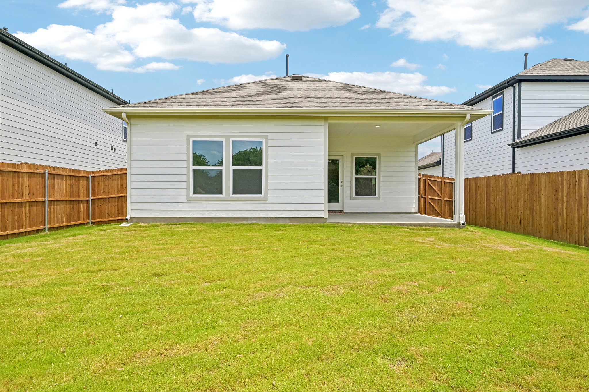 A house with a fence and grass.