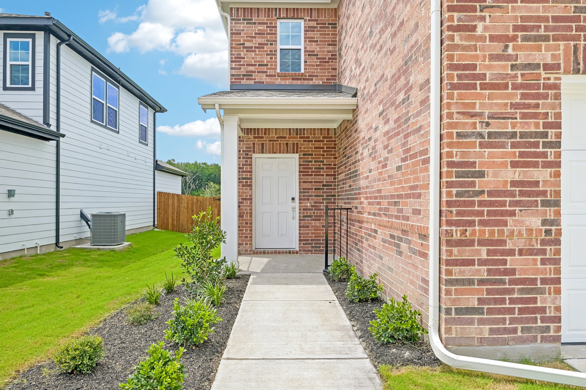 A brick building with a white door.