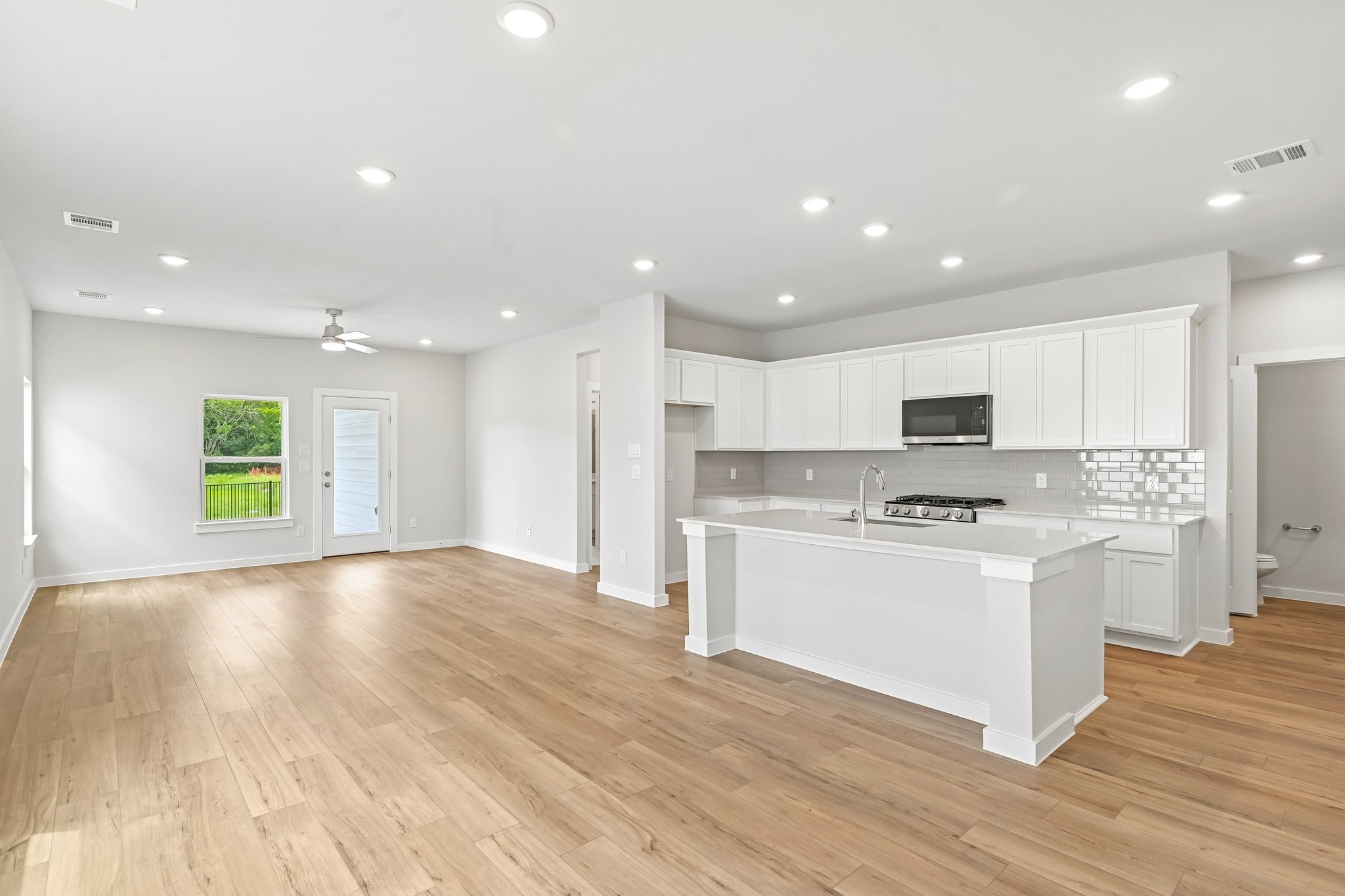 A kitchen with white cabinets.