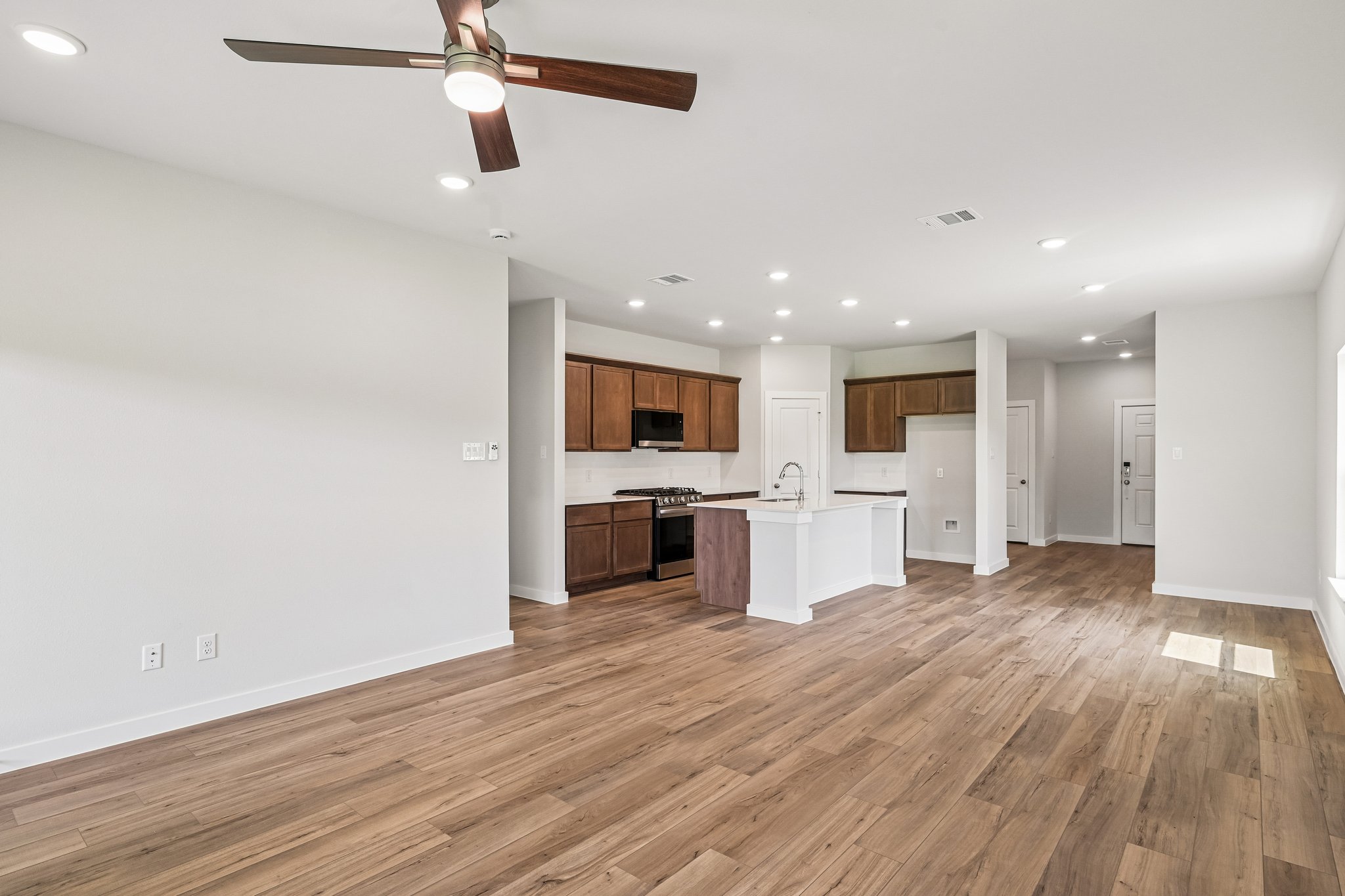 A large kitchen with a wood floor.