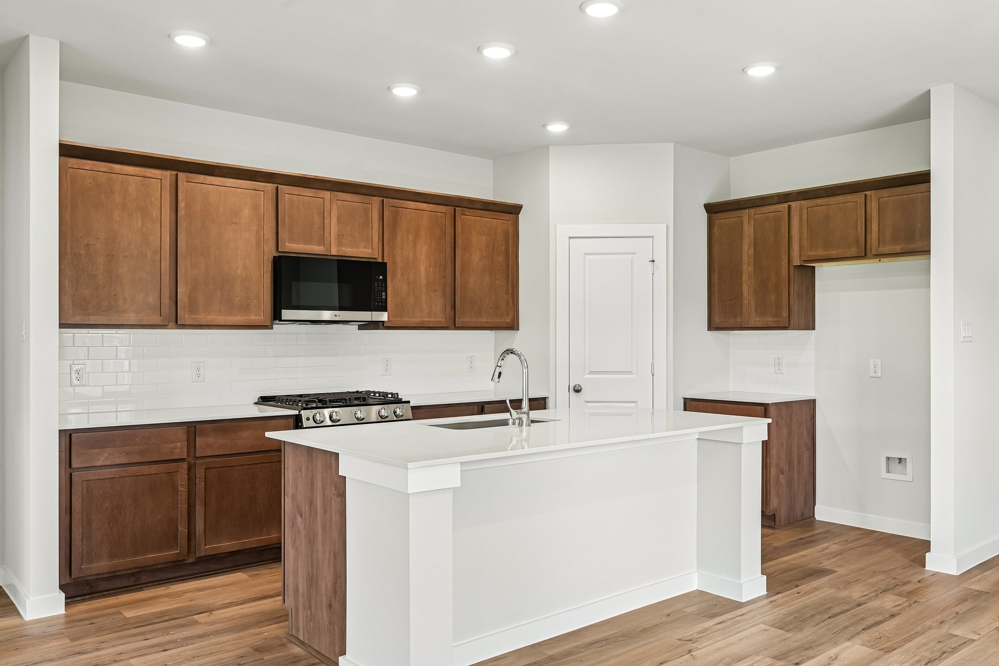 A kitchen with wooden cabinets.