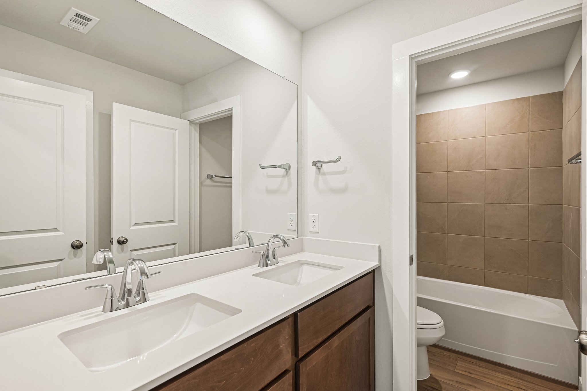 A bathroom with a tub sink and toilet.