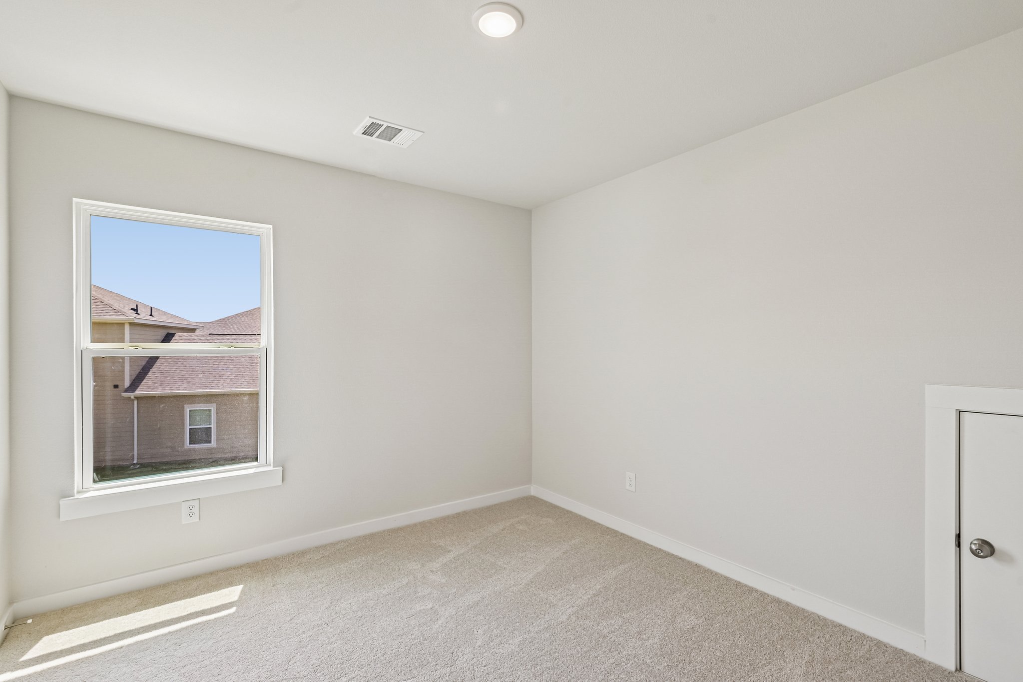 A room with a window and a door.