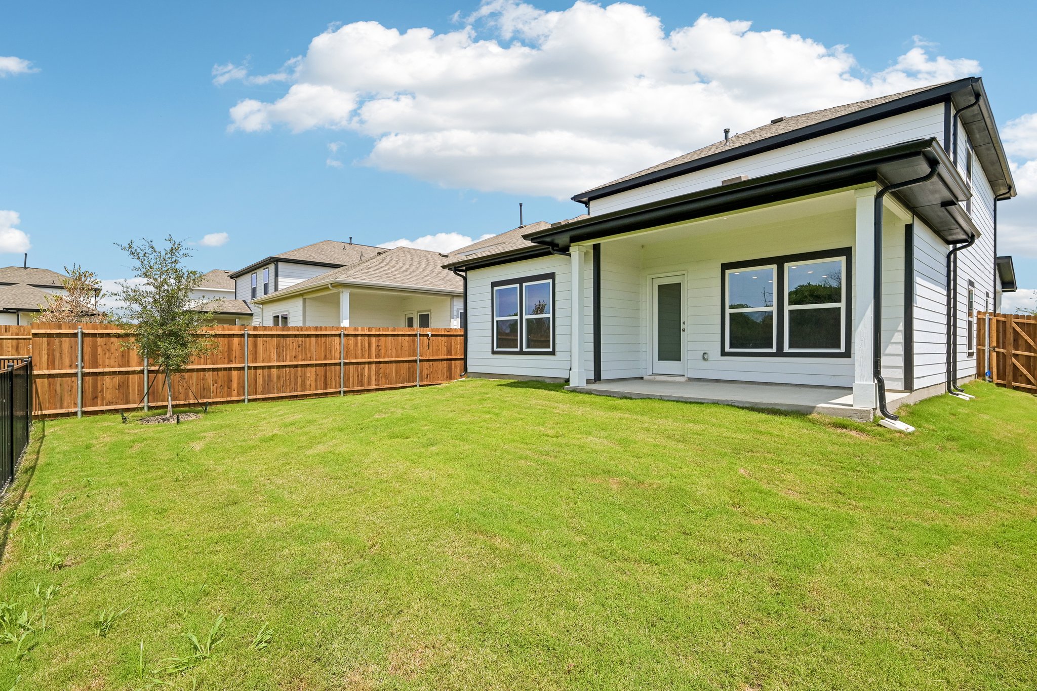 A house with a fence and grass.