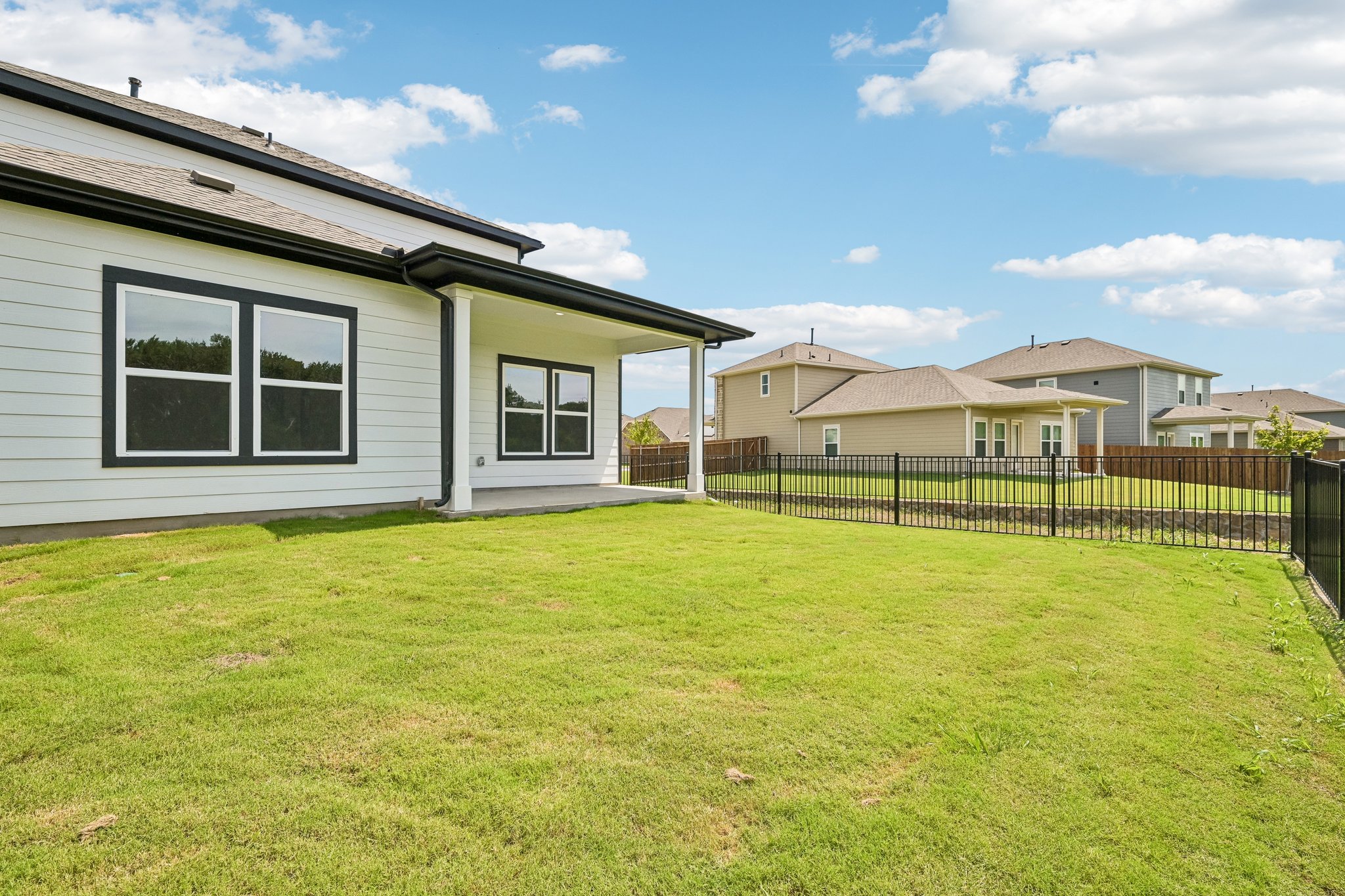 A house with a fence and grass.