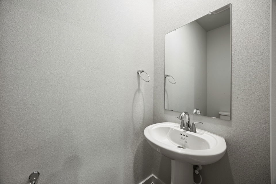 A bathroom with a mirror and sink.