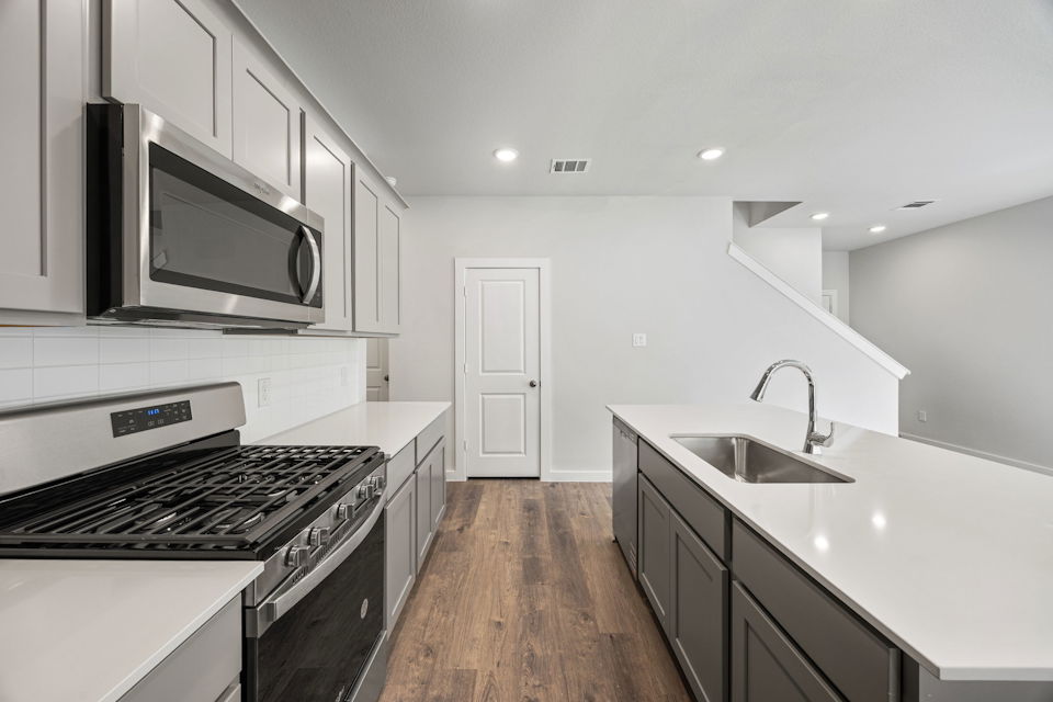 A kitchen with white cabinets.