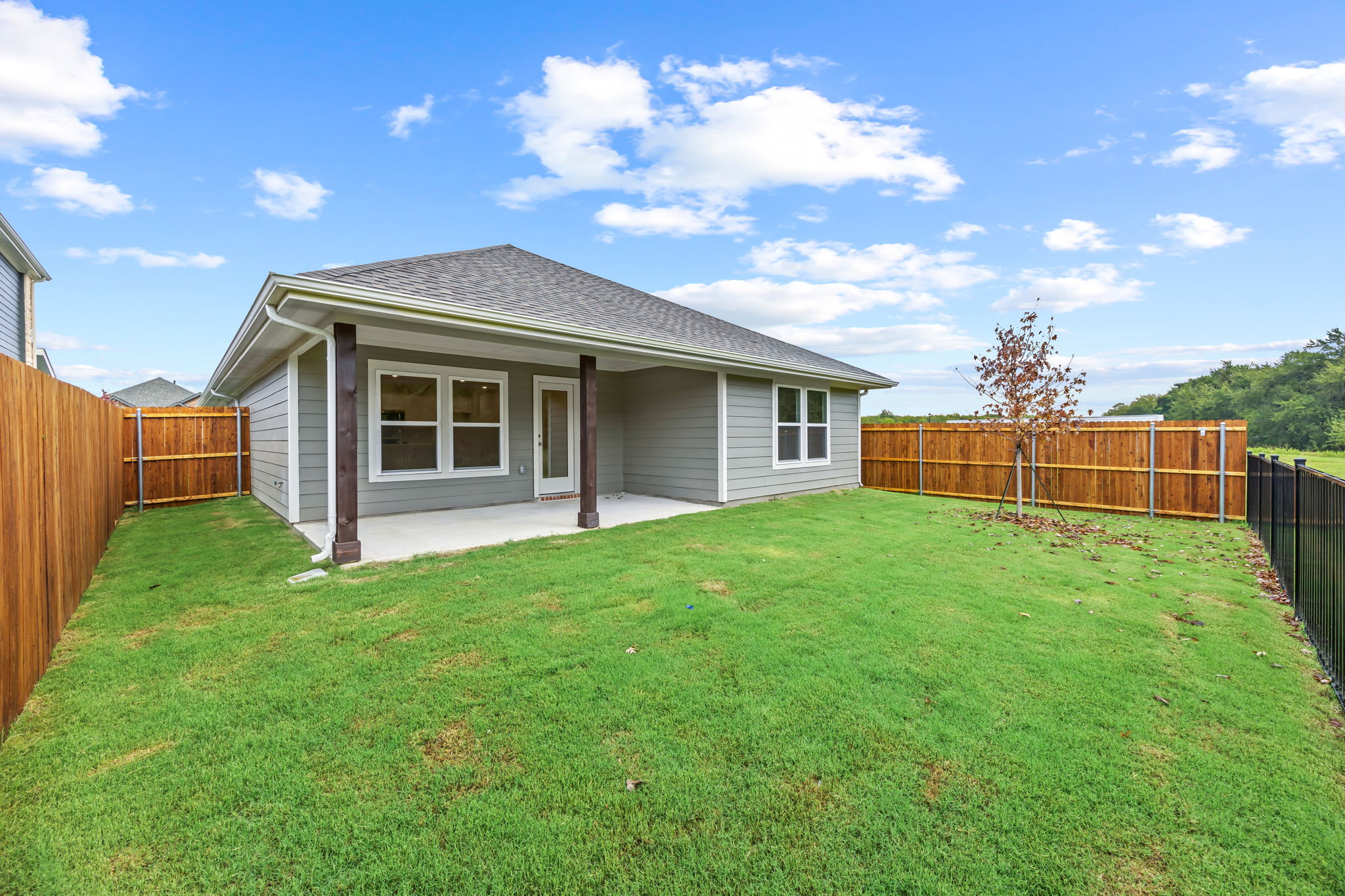 A house with a fence and grass.