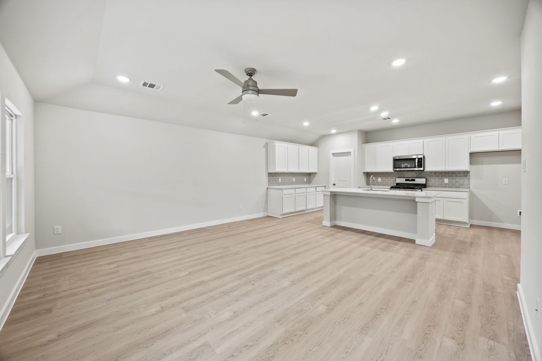 A large kitchen with white cabinets.