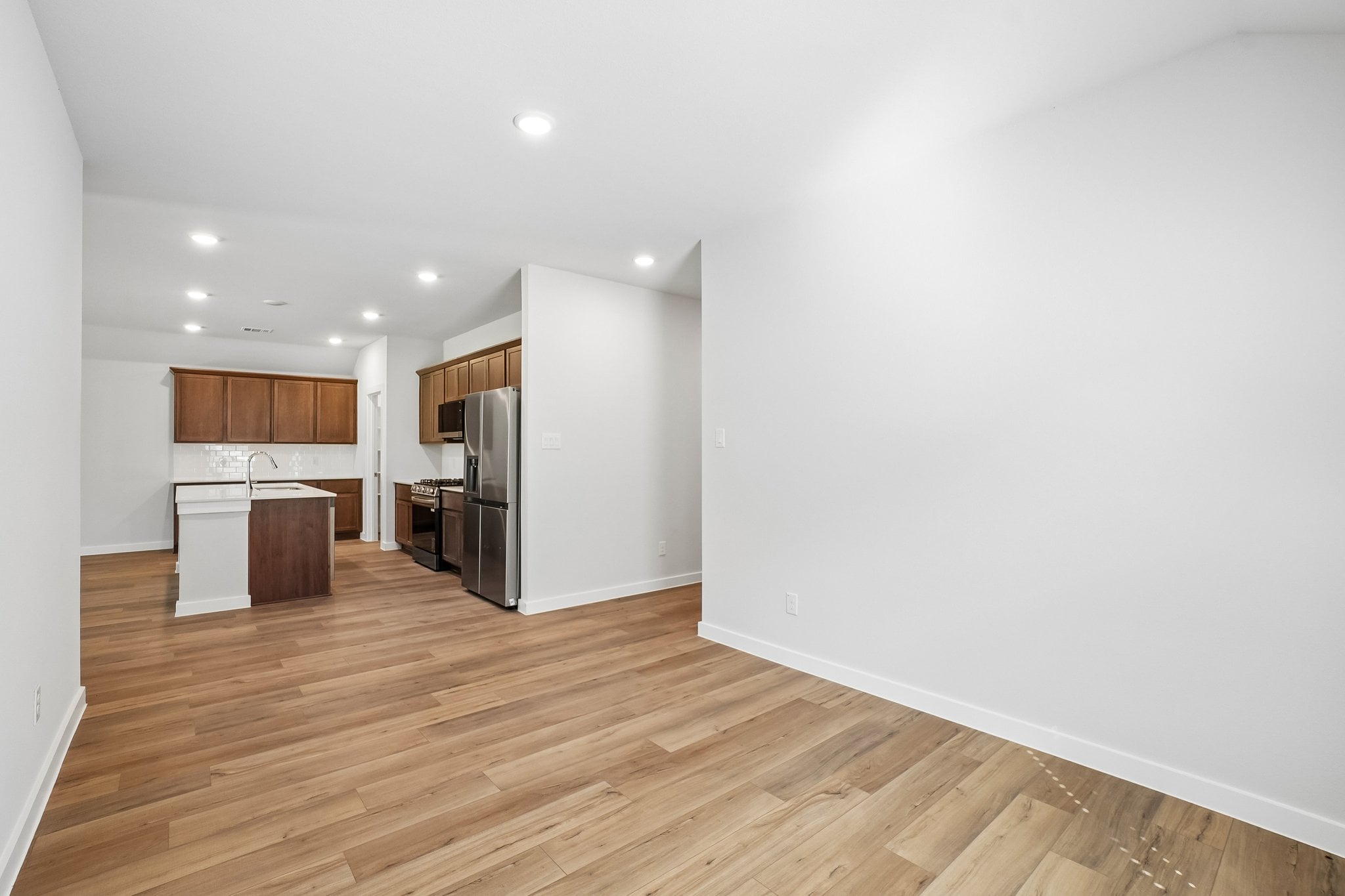 A kitchen with a wood floor.