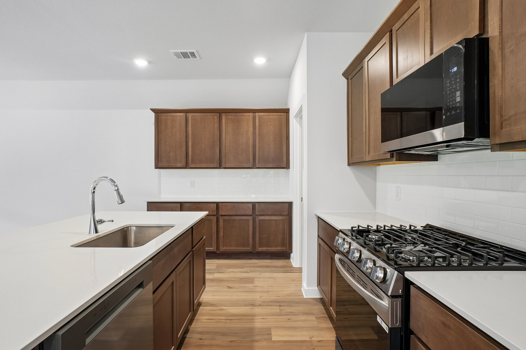 A kitchen with wooden cabinets.