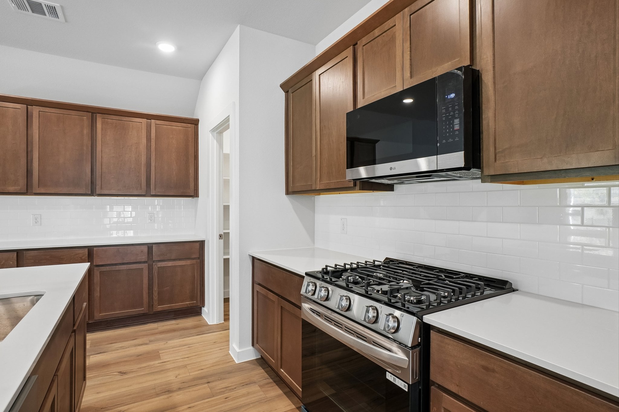 A kitchen with wooden cabinets.