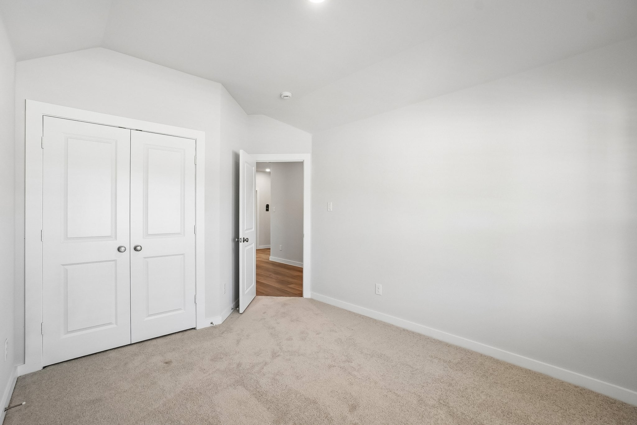 A hallway with white doors.
