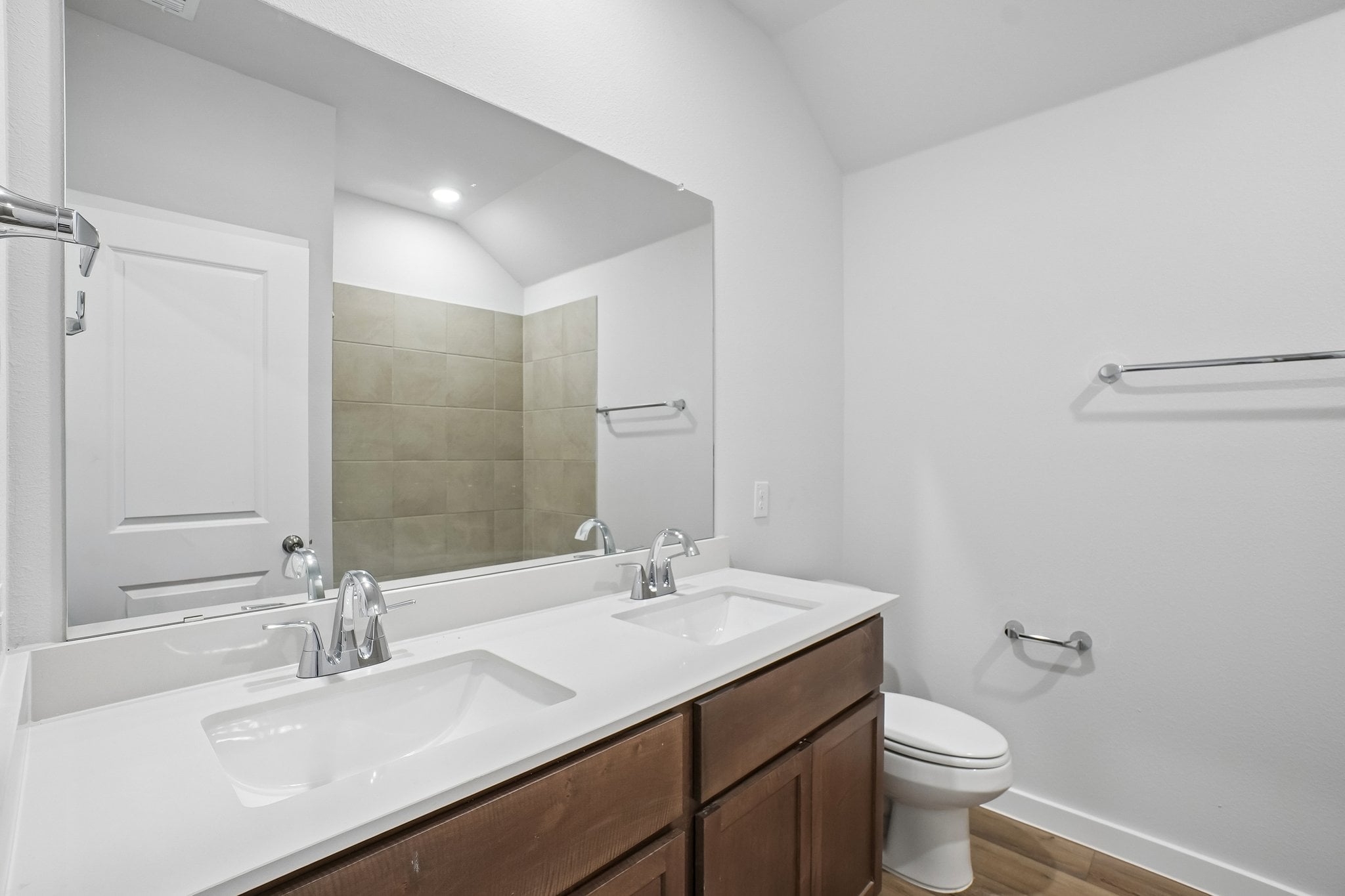 A bathroom with a large mirror.