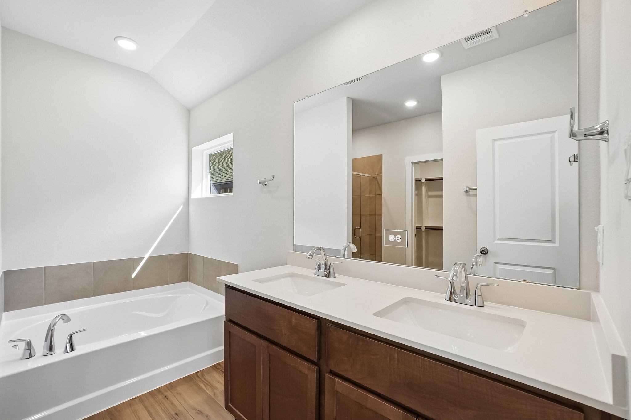 A bathroom with a large mirror.
