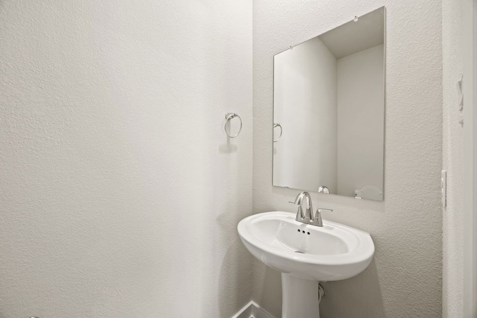 A bathroom with a mirror and sink.