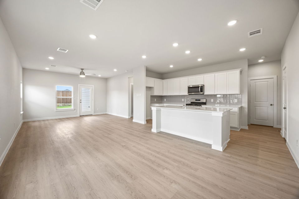 A large kitchen with white cabinets.