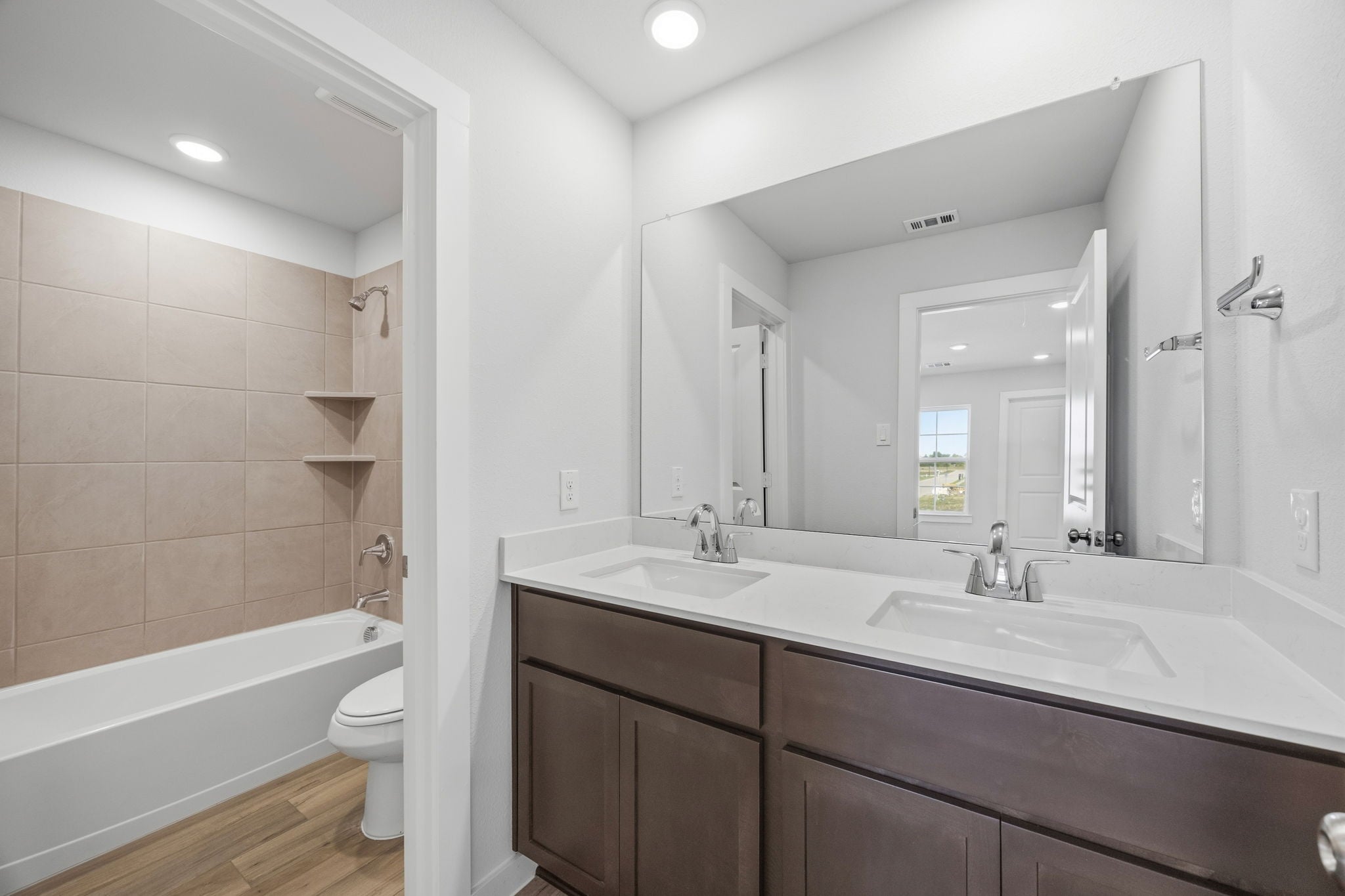 A bathroom with a tub sink and toilet.
