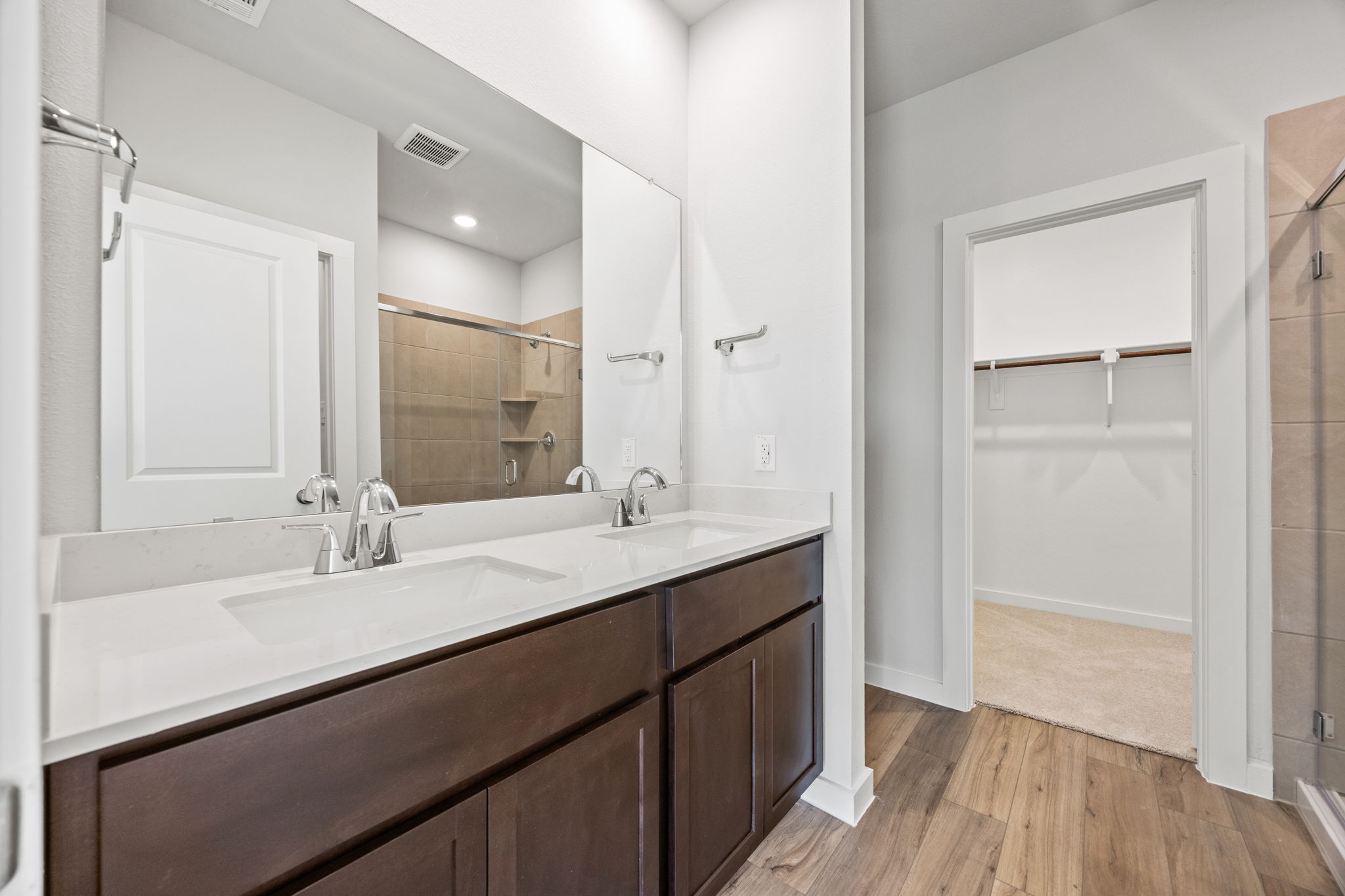 A bathroom with a large mirror.