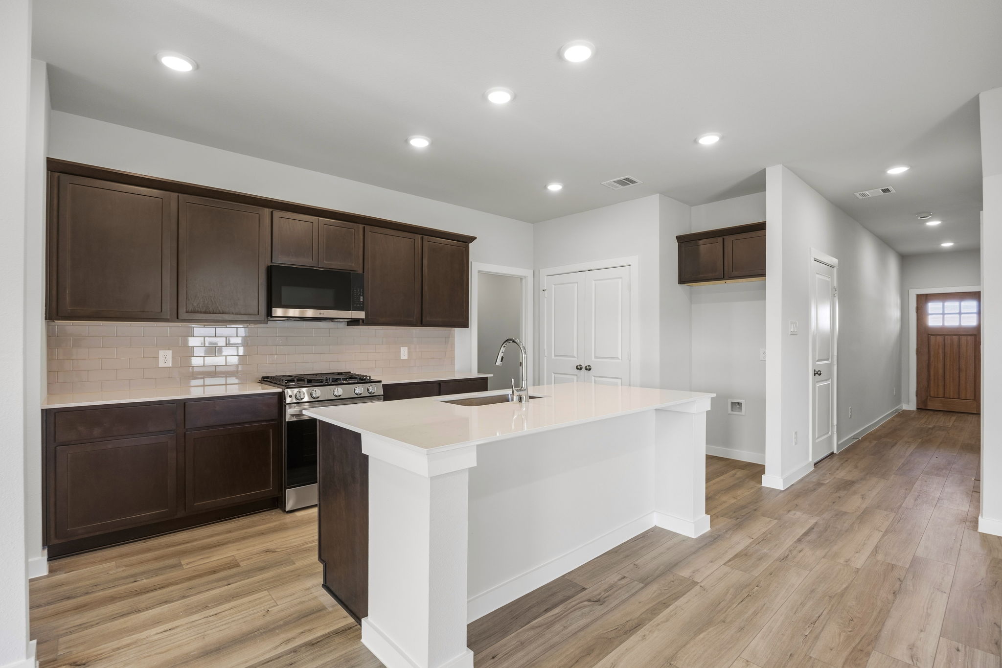 A kitchen with wooden cabinets.