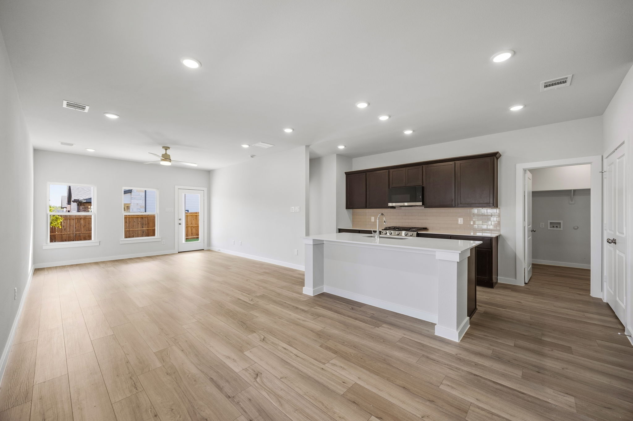 A large kitchen with a wood floor.