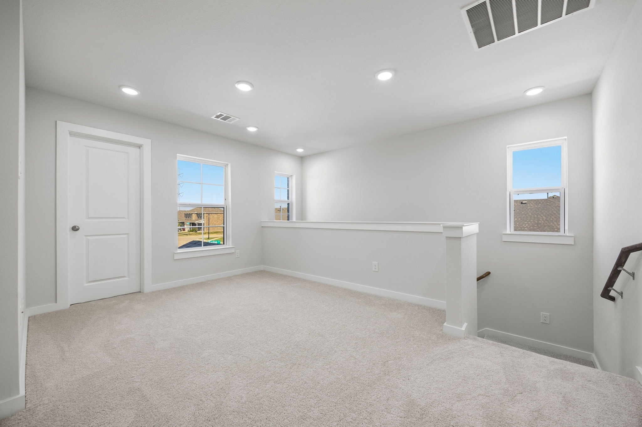 A room with a white bench and a window.