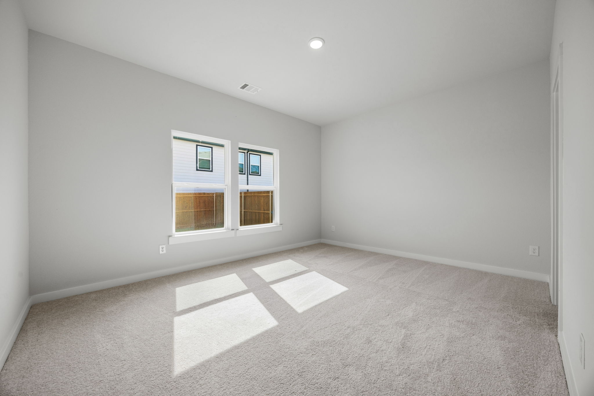 A room with a rug and a window.