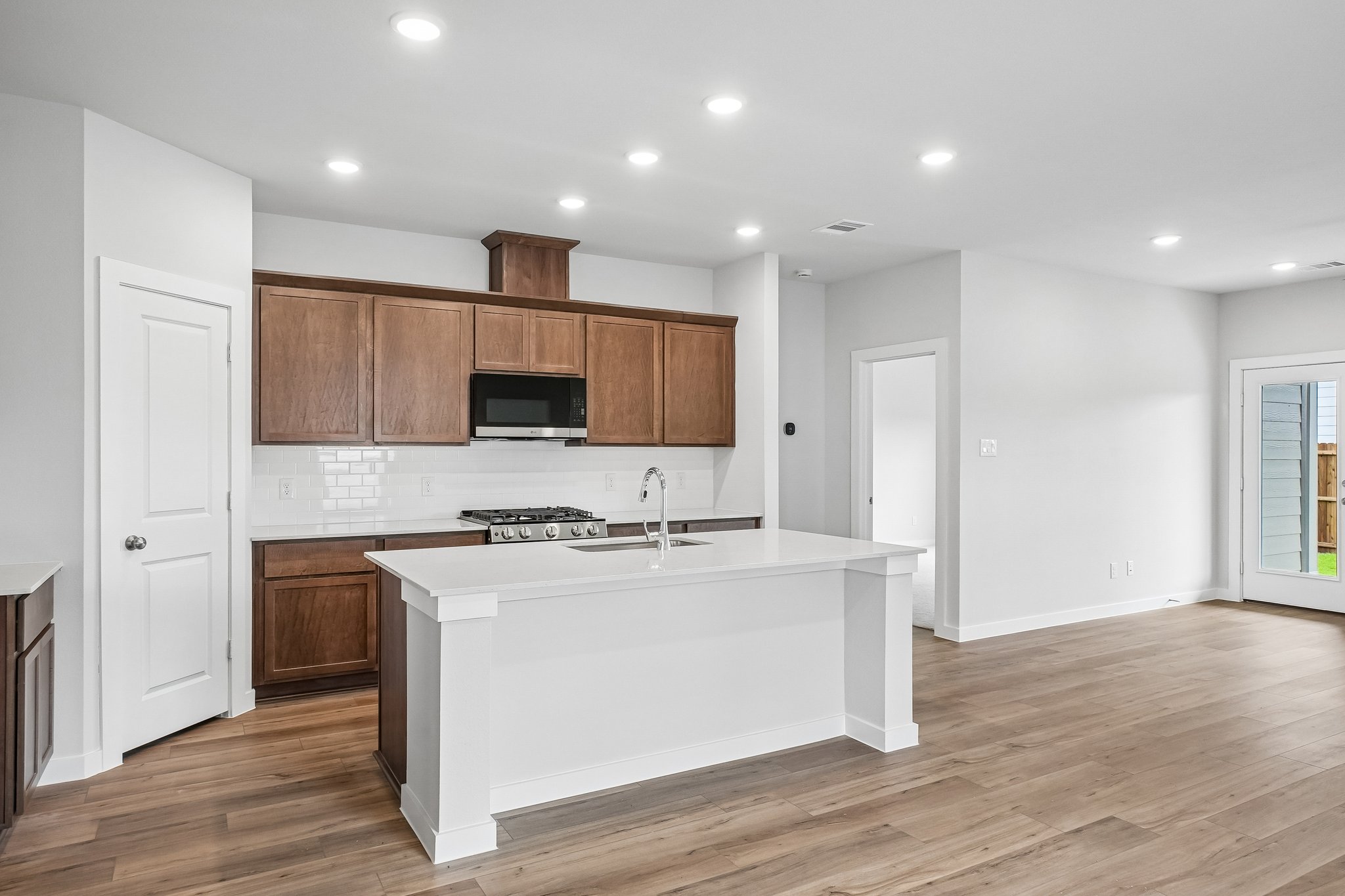 A kitchen with wooden cabinets.