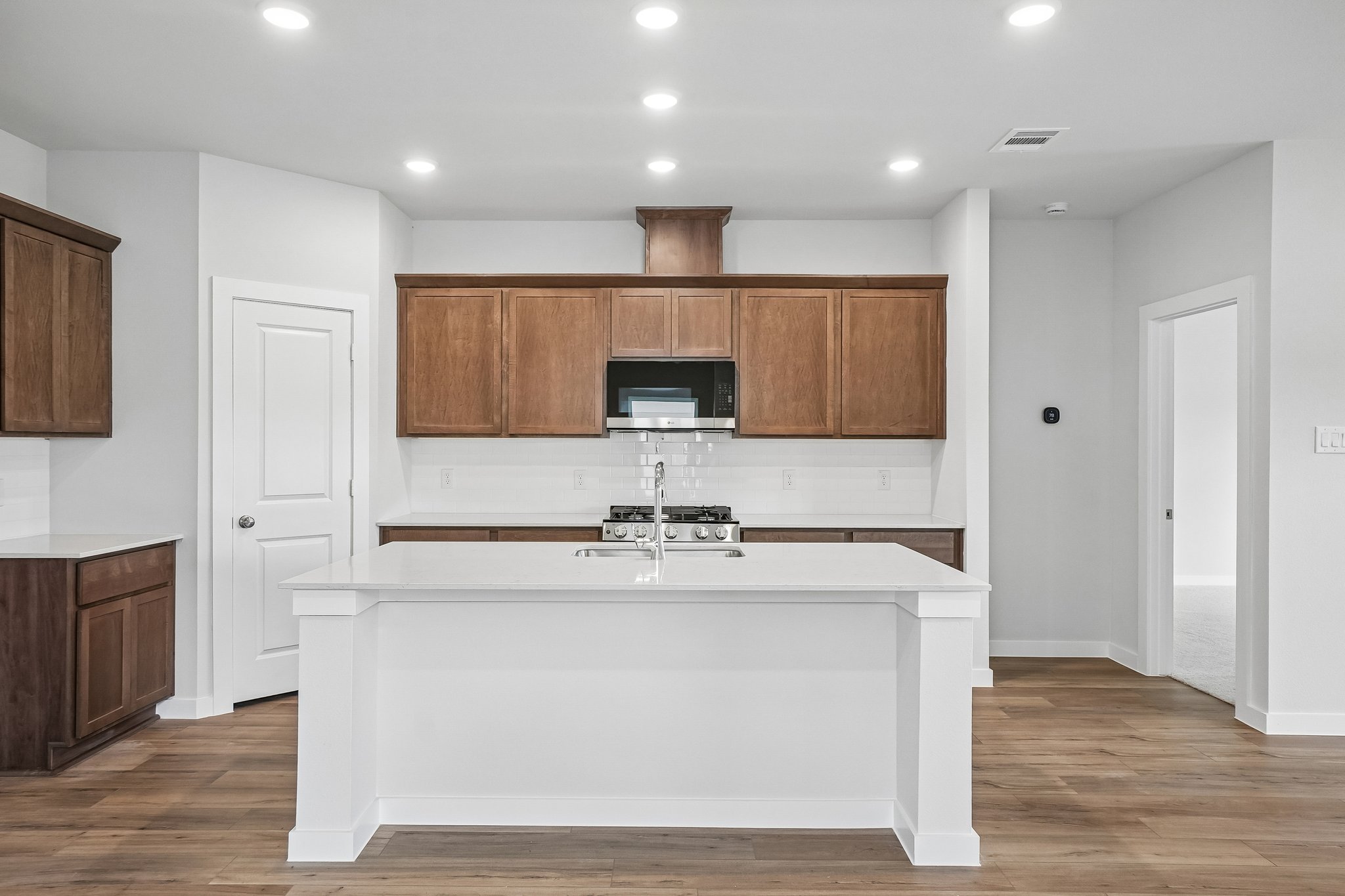 A kitchen with a white counter top.
