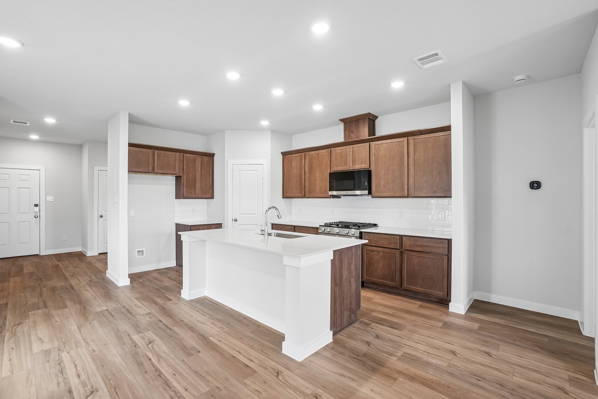 A kitchen with wooden cabinets.